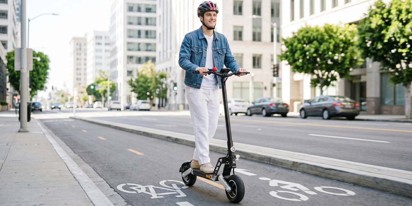 A young man wearing a helmet on a Todimart-G2ABE electric scooter: Black Todimart-G2ABE electric scooter (rugged tires) - casual wear, outdoor setting - perfect for city commuting.