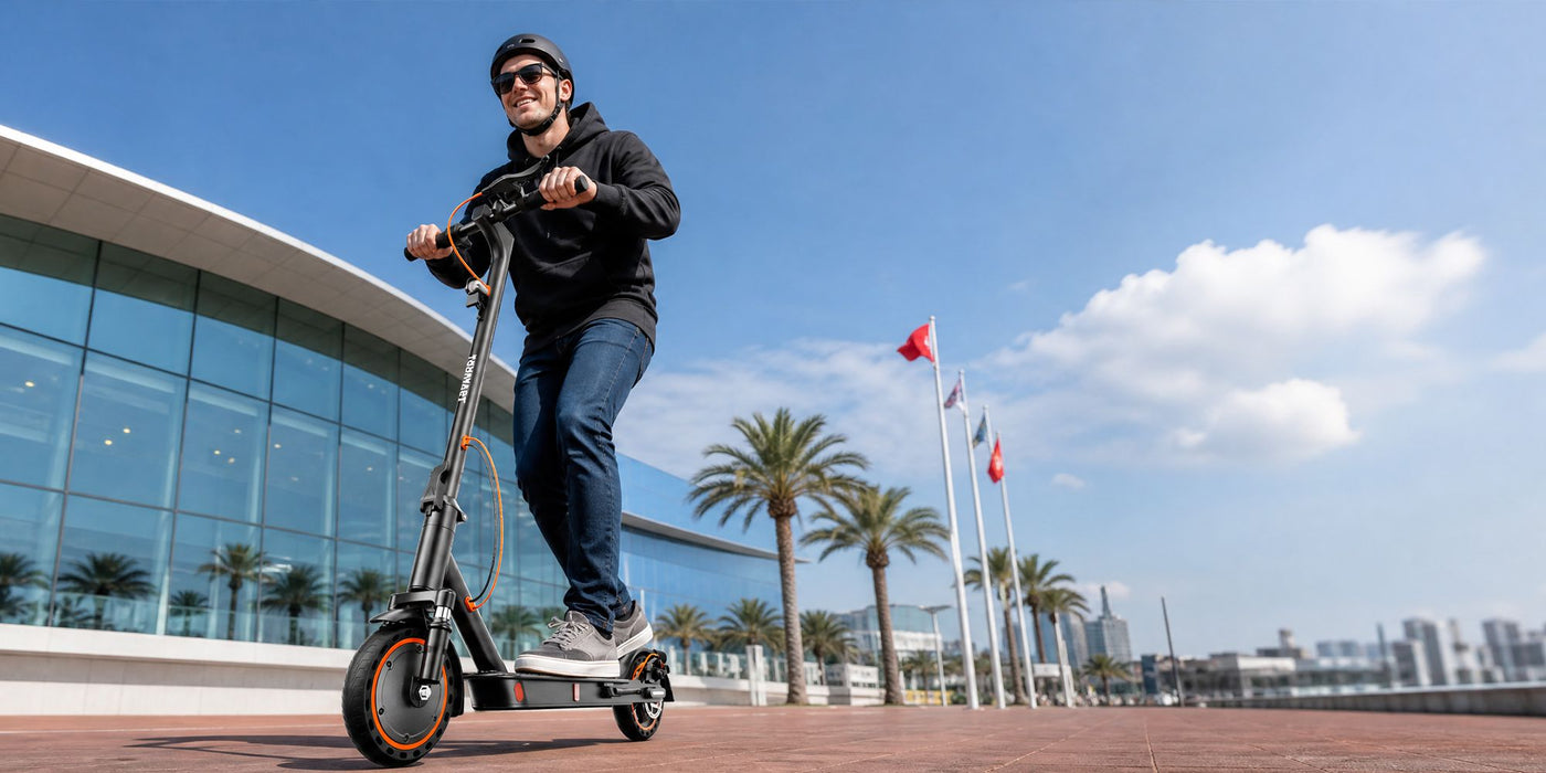 Young helmeted man on Todimart-T6ABE  electric scooter: Black Todimart-T6ABE e-scooter – casual wear, outdoor setting – ideal for urban commuting